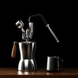 A stainless steel portable steam milk frother with a curved black steam wand, wooden handle, and matching black metal cup, shown on a wooden surface against a dark gray textured background. Orange text at the top reads 'PROFESSIONAL PORTABLE STEAM MILK FROTHE' with feature callouts.
