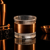 Glass container with wooden band on a gray background