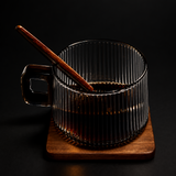 Clear glass mug with wooden handle and coaster on a white background, featuring the brand 'BenRussell'.