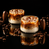 A styled coffee scene showing an iced coffee drink in a clear glass cup with a dark wooden handle, placed on a wooden table beside an open book and spoon. White text at the top reads 'Bincoo Aesthetic coffee' with a subtitle about ritual coffee.